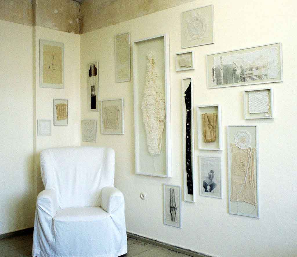 „Großmuttersessel" Installation, gerahmte textile Skizzen, Fotos und Dokumente der Großmutter auf Stoff, Sessel mit weißer Housse